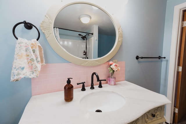 bathroom with walk in shower, sink, and backsplash