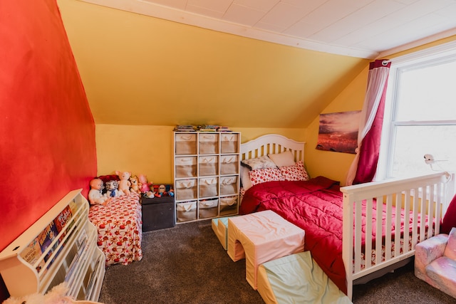 carpeted bedroom with lofted ceiling