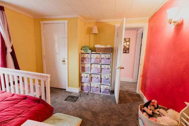 bedroom featuring dark colored carpet and crown molding