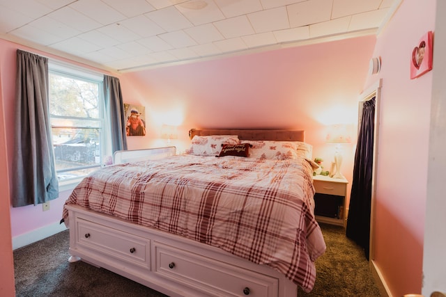 carpeted bedroom featuring crown molding