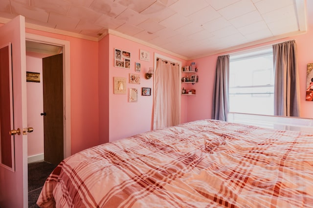 carpeted bedroom with ornamental molding