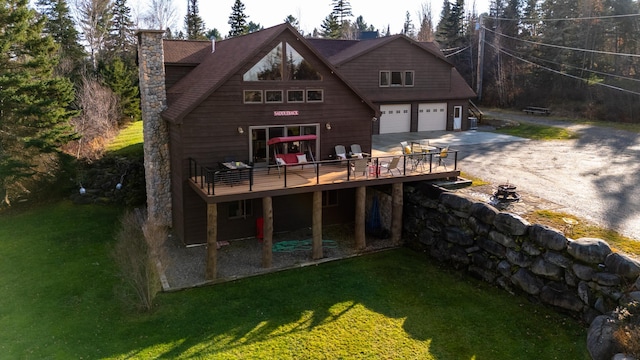 8 Hilltop Hts, Rangeley, ME 04970 - rear view of house with a wooden deck, concrete driveway, a chimney, and a yard