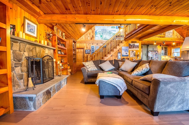 8 Hilltop Hts, Rangeley, ME 04970 - living area with stairs, wood finished floors, a fireplace, wood walls, and wood ceiling
