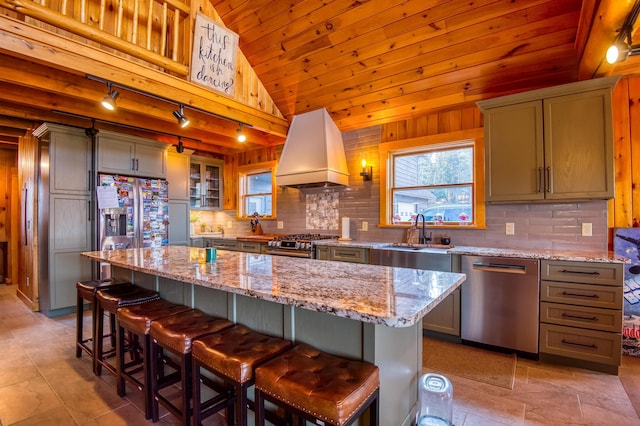 8 Hilltop Hts, Rangeley, ME 04970 - kitchen with appliances with stainless steel finishes, custom exhaust hood, a sink, lofted ceiling, and rail lighting