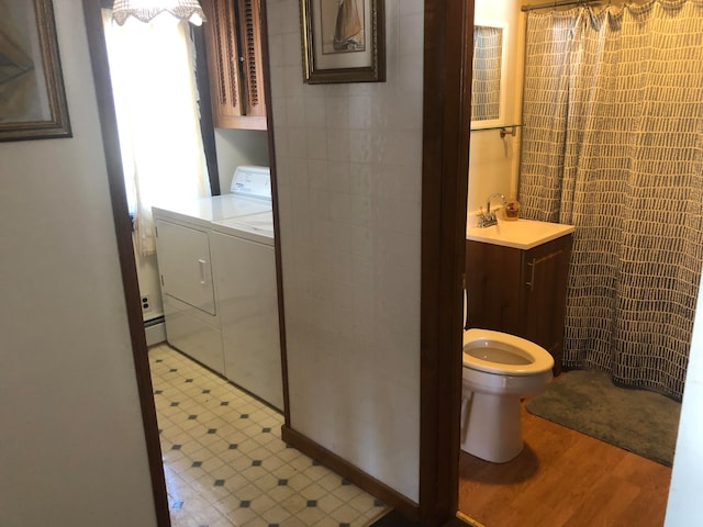 bathroom with washer and clothes dryer, vanity, toilet, and hardwood / wood-style flooring