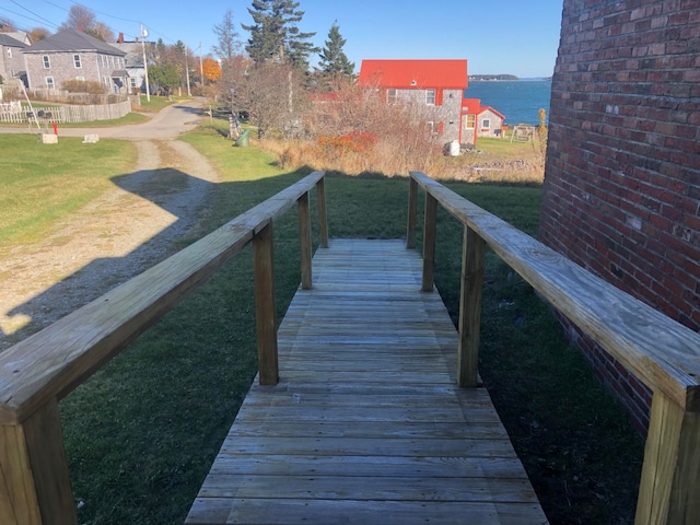 view of dock featuring a yard and a water view