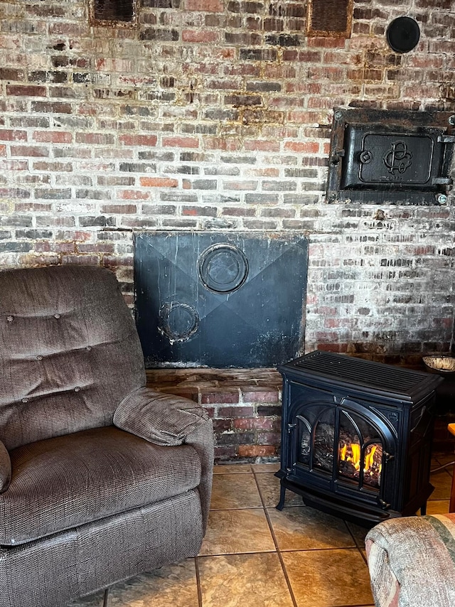 interior details featuring tile patterned flooring and a wood stove