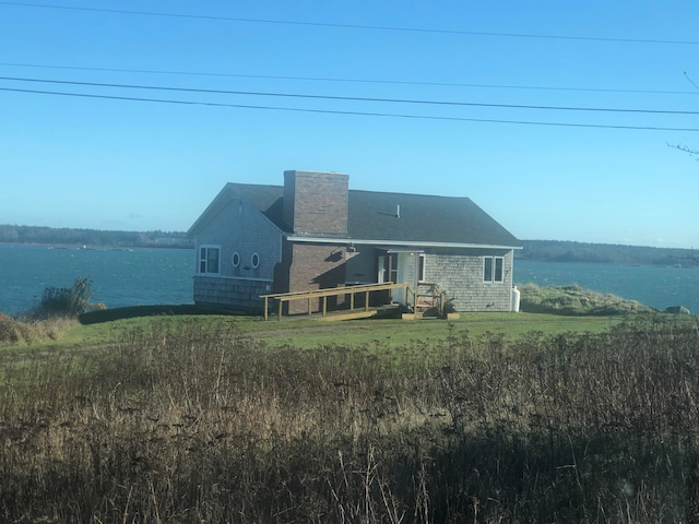 rear view of property with a water view