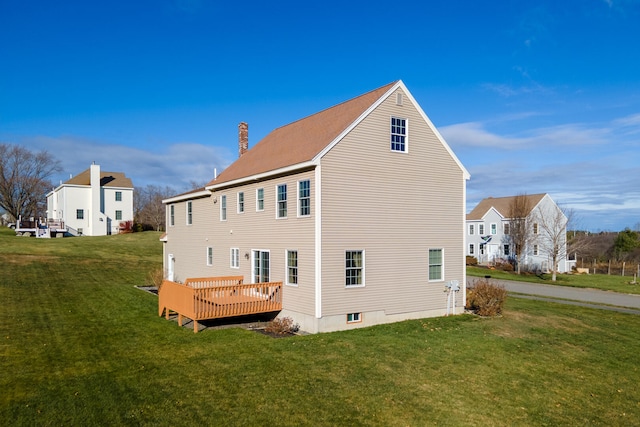 back of house with a yard and a wooden deck