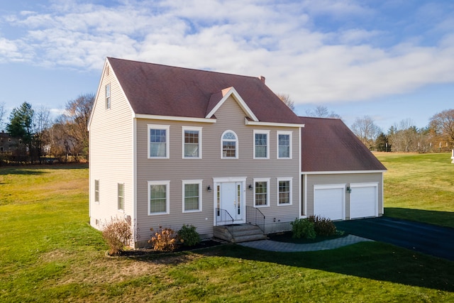 colonial-style house with a garage and a front yard