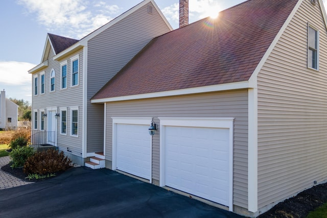 view of property exterior with a garage