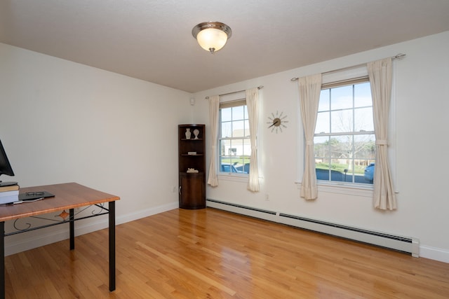 office with baseboard heating and light hardwood / wood-style floors