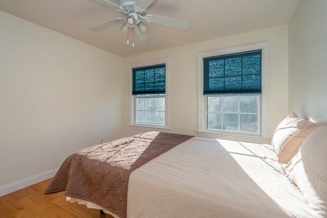 bedroom with light hardwood / wood-style floors and ceiling fan