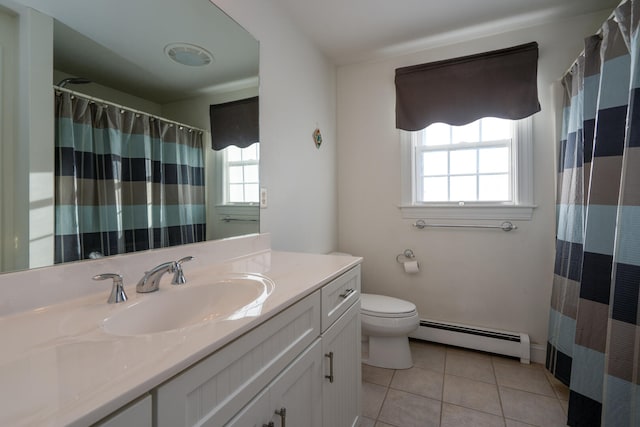 bathroom featuring tile patterned flooring, plenty of natural light, vanity, and a baseboard heating unit