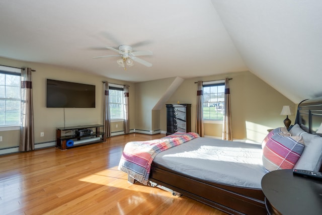 bedroom featuring ceiling fan, lofted ceiling, and light wood-type flooring