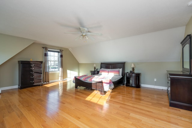 bedroom featuring light hardwood / wood-style flooring, ceiling fan, and lofted ceiling