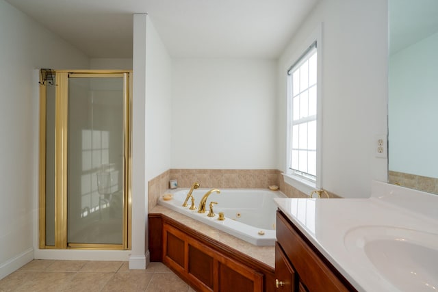 bathroom with tile patterned flooring, vanity, and shower with separate bathtub