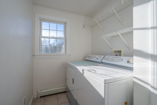 laundry area with light tile patterned flooring, washing machine and dryer, and baseboard heating