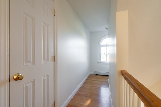 corridor featuring light hardwood / wood-style floors and a baseboard heating unit