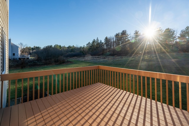 wooden terrace with a lawn