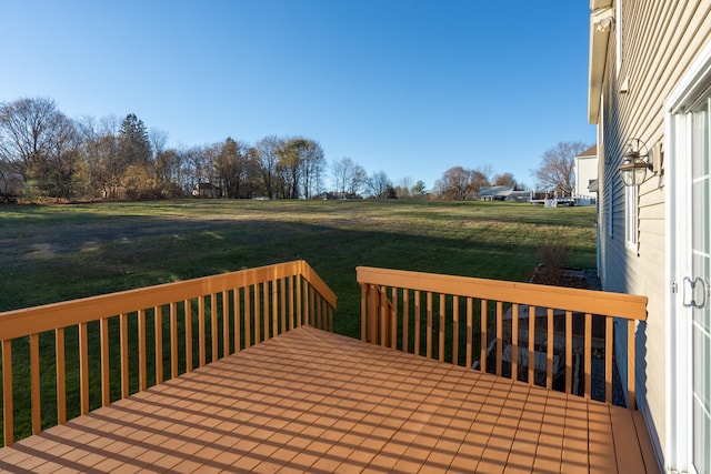 wooden terrace featuring a yard