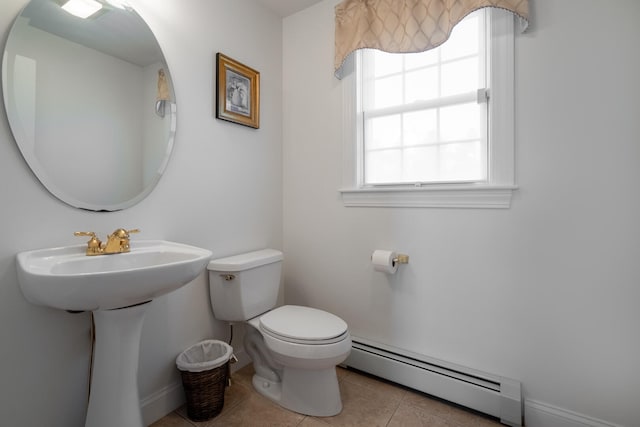 bathroom featuring tile patterned flooring, sink, toilet, and baseboard heating