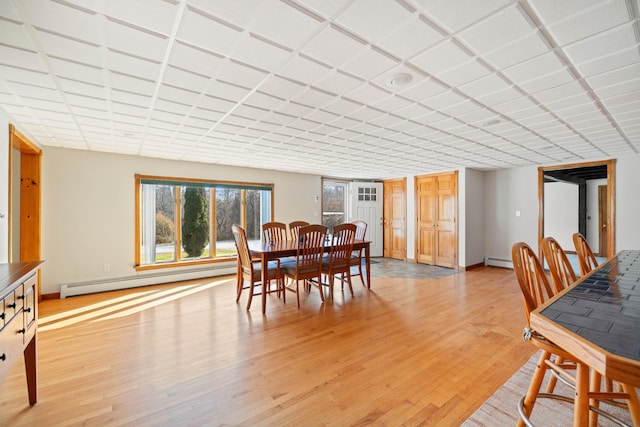 dining room featuring light wood-type flooring and a baseboard radiator