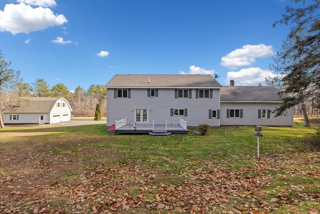 back of house featuring a lawn and a deck