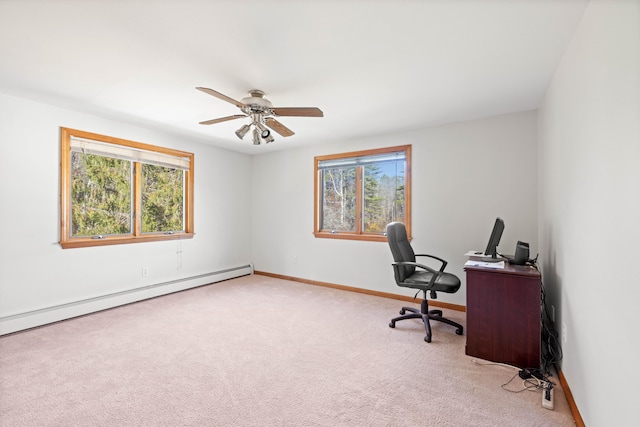 carpeted office with a baseboard heating unit, plenty of natural light, and ceiling fan