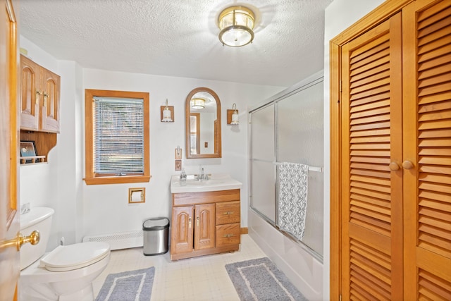 full bathroom featuring toilet, bath / shower combo with glass door, vanity, and a textured ceiling