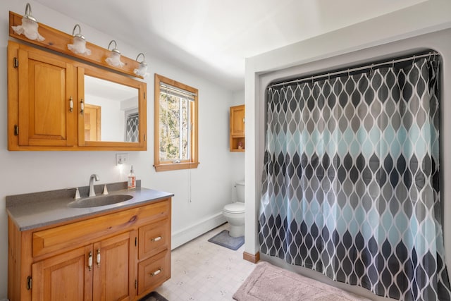 bathroom featuring toilet, vanity, and a baseboard radiator