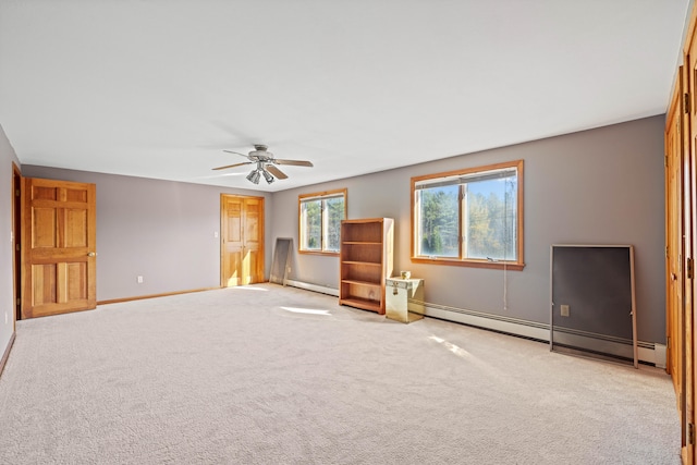 unfurnished living room featuring ceiling fan, baseboard heating, and light carpet