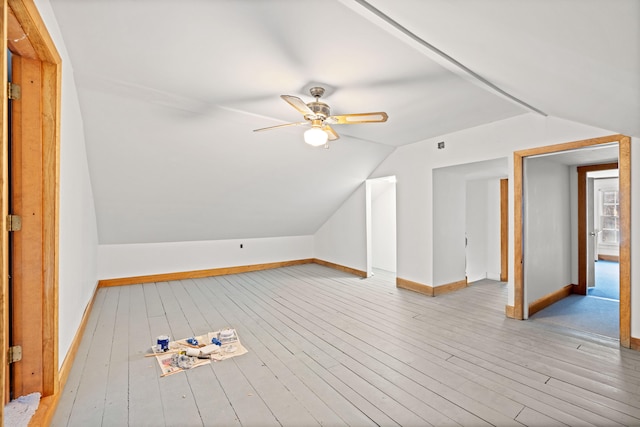 additional living space with ceiling fan, light hardwood / wood-style flooring, and vaulted ceiling