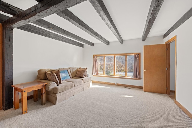 unfurnished living room with light colored carpet and beam ceiling