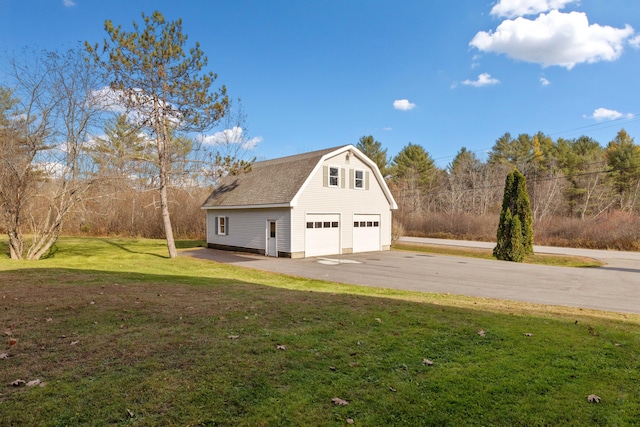 garage featuring a lawn