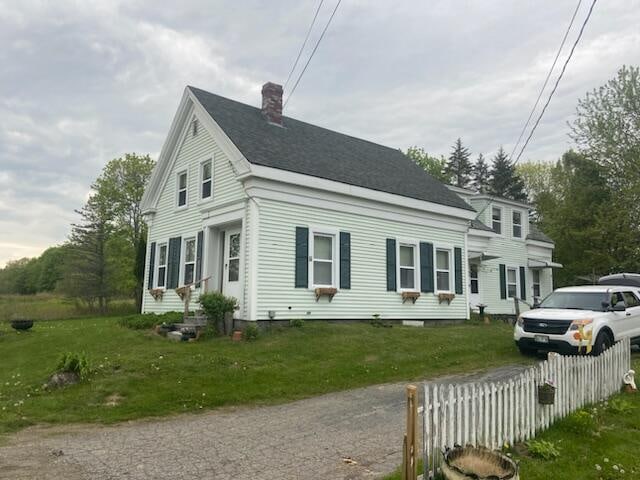 view of side of property with a lawn