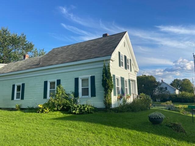 view of side of property with a yard