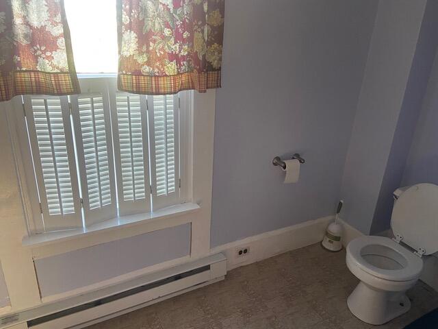 bathroom featuring toilet and a baseboard radiator