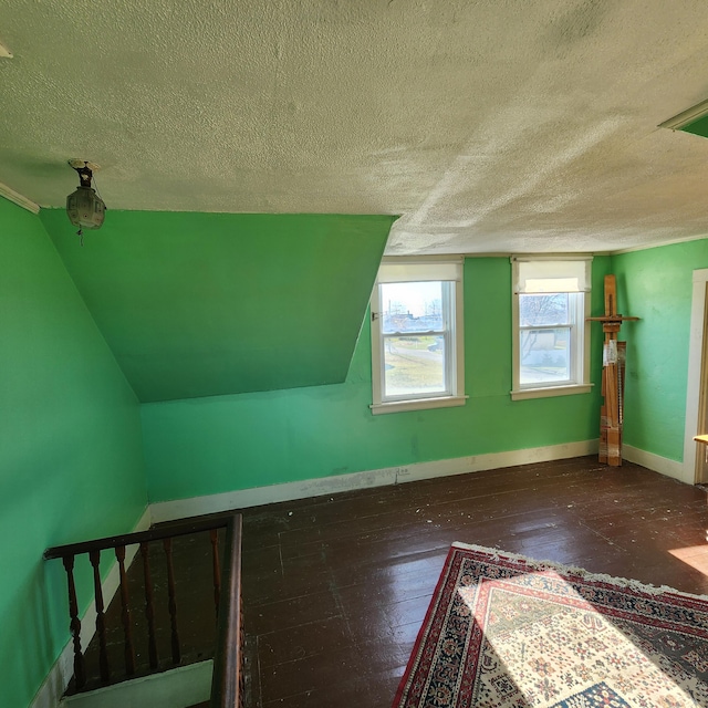 additional living space with a textured ceiling