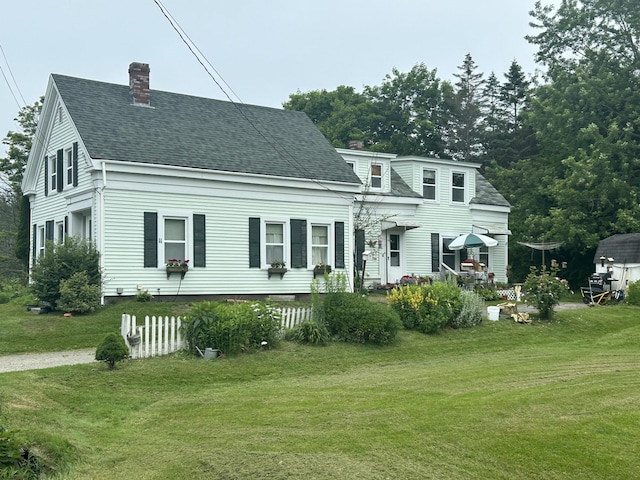 rear view of property with a yard