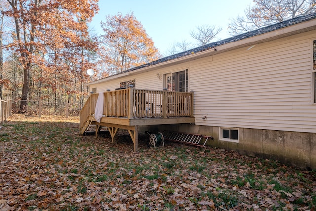 rear view of property with a wooden deck