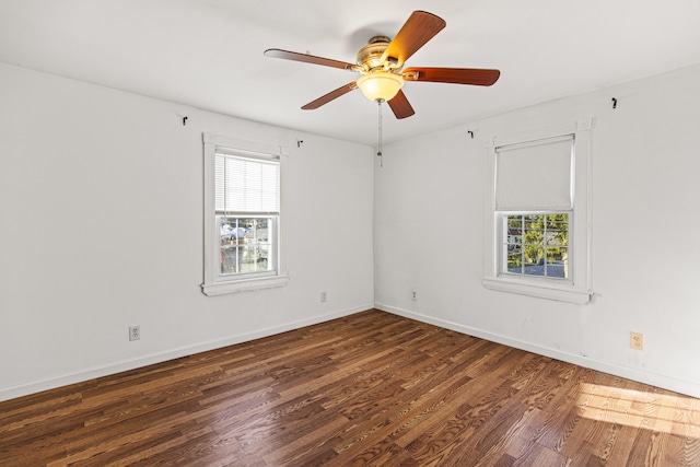 spare room featuring dark hardwood / wood-style flooring and ceiling fan