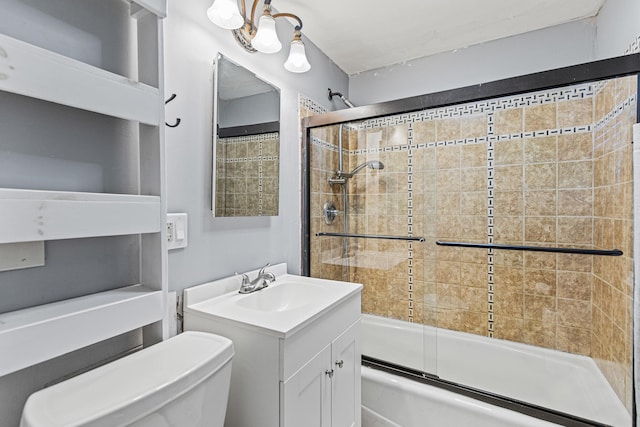 full bathroom featuring bath / shower combo with glass door, vanity, and toilet