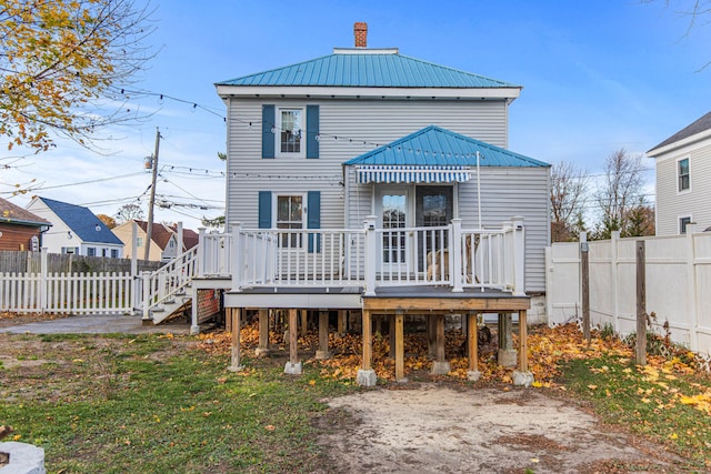 rear view of property with a wooden deck