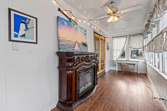 interior space featuring wooden walls, hardwood / wood-style flooring, and ceiling fan