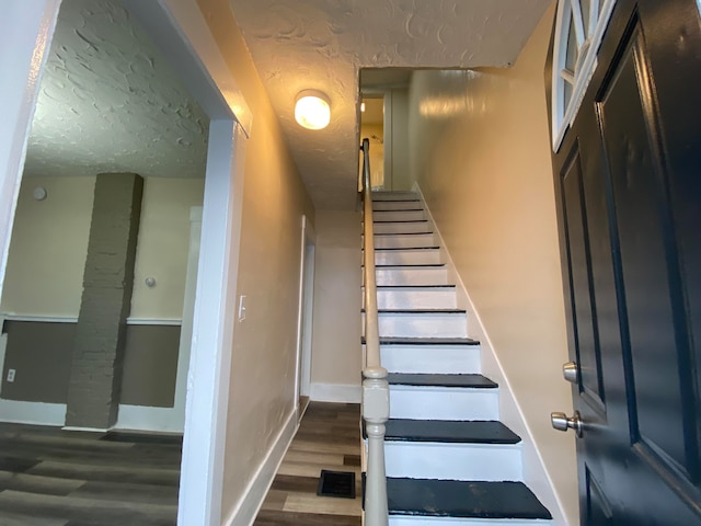 staircase featuring hardwood / wood-style floors