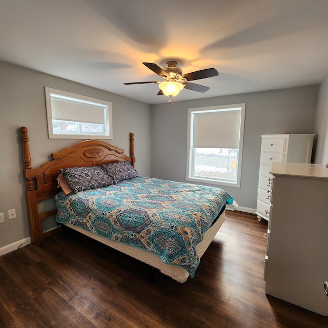 bedroom with dark hardwood / wood-style flooring and ceiling fan