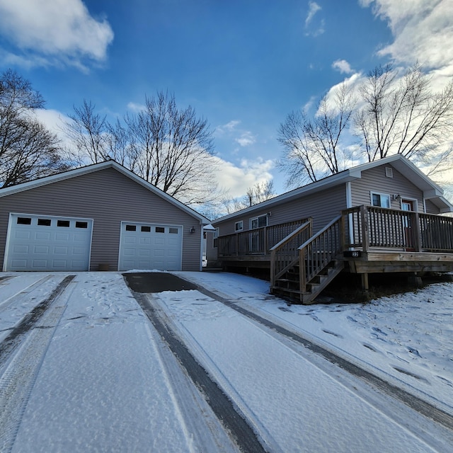 view of snowy exterior featuring a deck