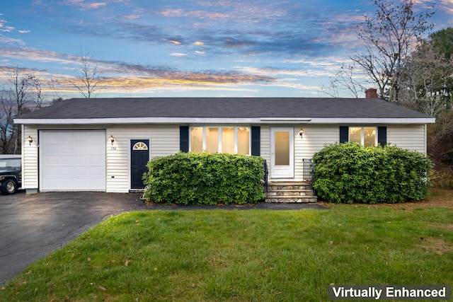 single story home with a lawn and a garage