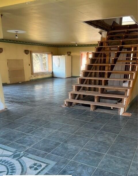 interior space with white fridge and dark tile patterned floors